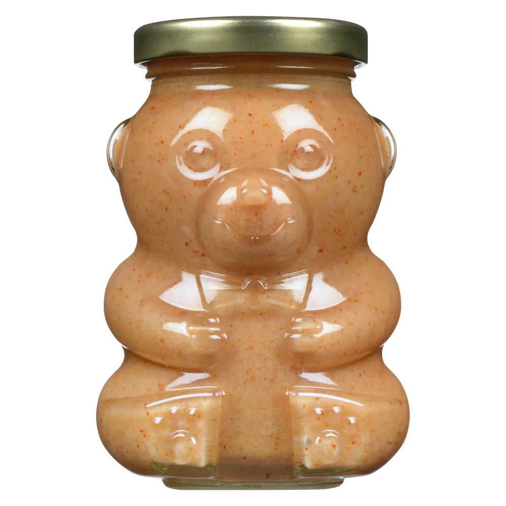 A jar of peanut butter shaped like a bear.