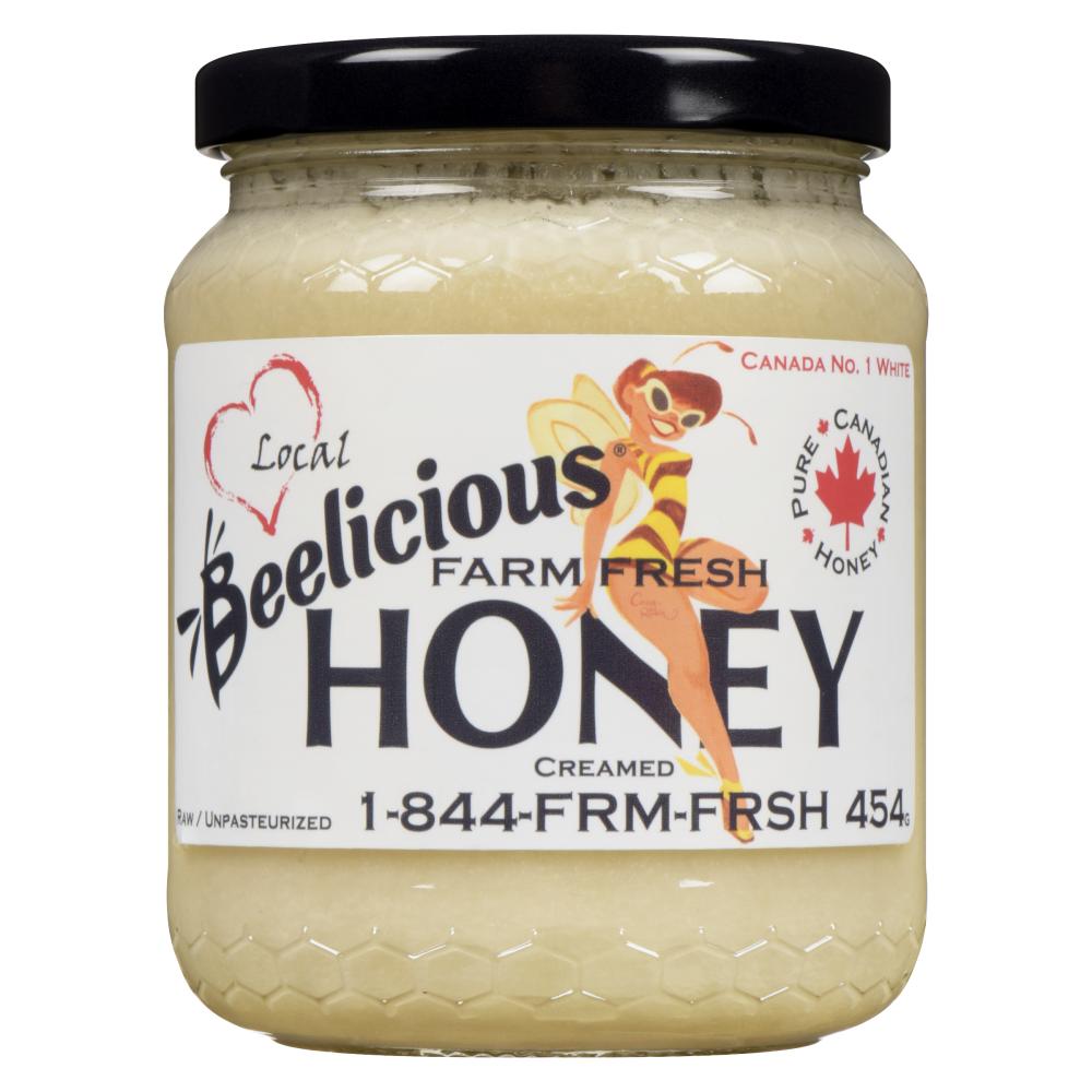 Jar of Beelicious Farm Fresh Honey with label and black lid.
