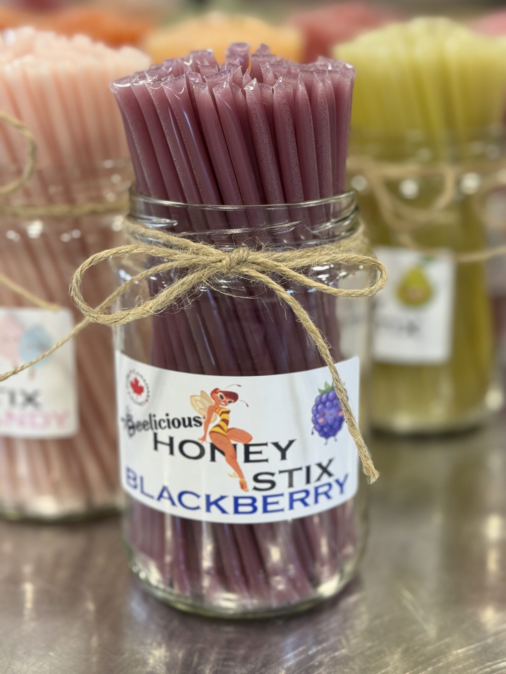 Jar of purple honey sticks labeled 'Honey Stix Blackberry'.