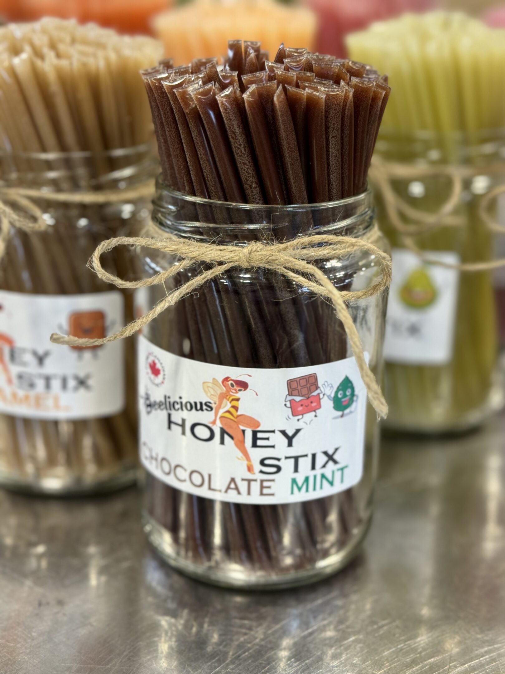 Jar of chocolate mint honey stix tied with twine.