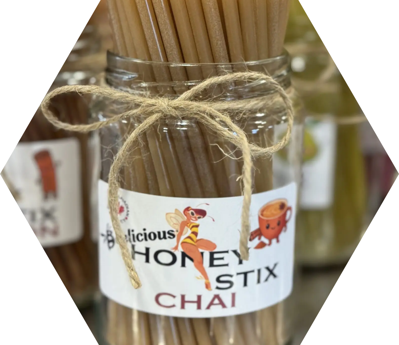 A container of honey-flavored sticks tied with twine.